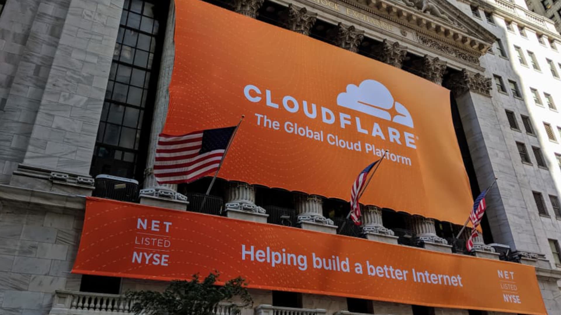 Cloudflare banner with united states flags. Banner saysL helping build a better internet