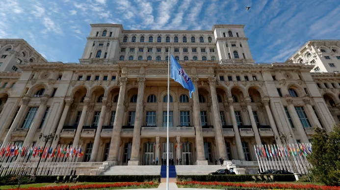 The flag of the International Telecommunication Union flies in front of the Parliament Building in Bucharest where the ITU’s next secretary-general will be elected on Thursday